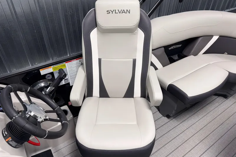 Slide: The Image of 2026 Sylvan Mirage X1 LZ DH boat interior with sleek captain's chair and modern steering wheel. - 7