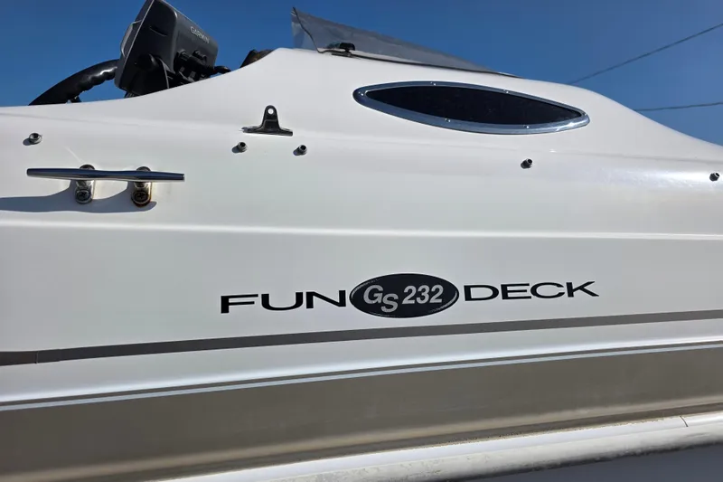 Slide: The Image of 2004 Hurricane FunDeck GS 232 OB boat side view with logo and details. - 3