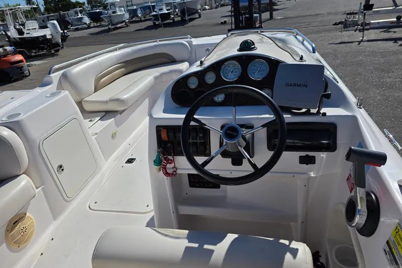 Slide: The Image of 2004 Hurricane FunDeck GS 232 OB boat interior with steering wheel and Garmin navigation system. - 4