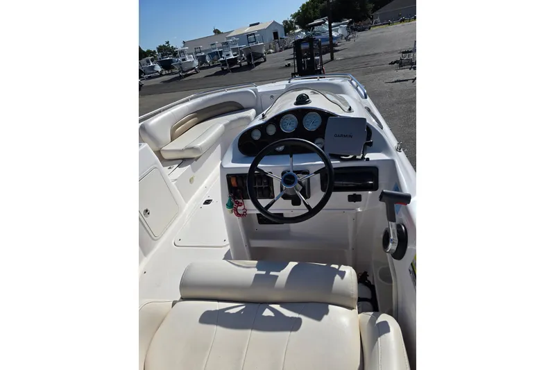 Slide: The Image of 2004 Hurricane FunDeck GS 232 OB boat interior with steering wheel and Garmin device. - 5