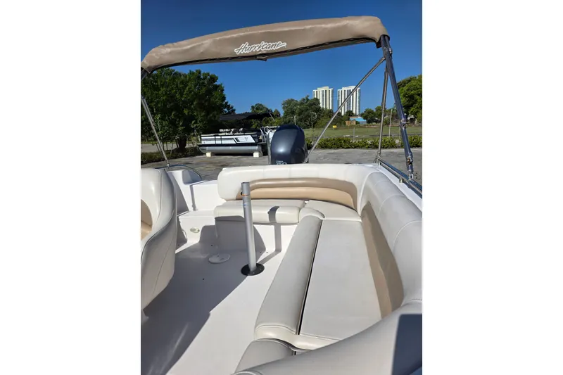 Slide: The Image of 2004 Hurricane FunDeck GS 232 OB boat interior with seating and canopy. - 7