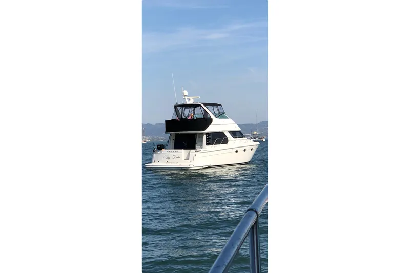 The Image of 2006 Carver 46 Voyager yacht cruising on open water. - 1