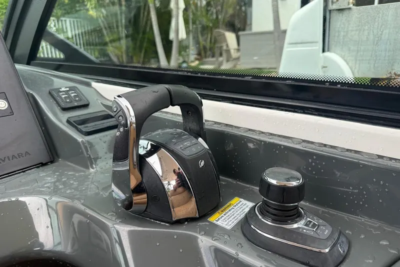 Slide: The Image of Twin Mercury outboard engines on a 2022 Aviara AV32 OB boat docked by waterfront homes. - 15