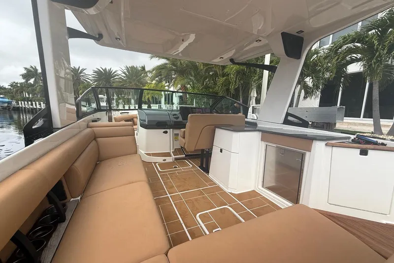 Slide: The Image of 2022 Aviara AV32 OB boat with spacious seating and sleek design docked by a canal. - 5