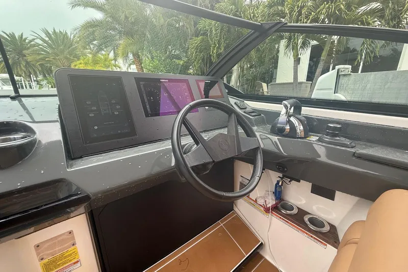 Slide: The Image of 2022 Aviara AV32 OB boat cockpit with modern controls and steering wheel. - 7