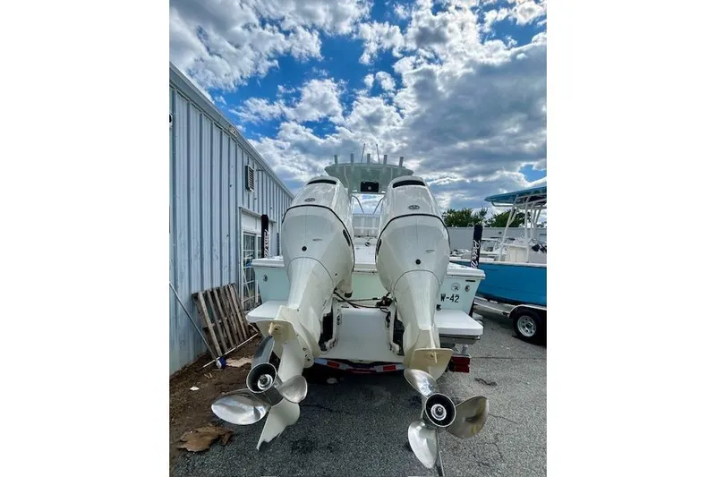 Slide: The Image of 2020 Pair Customs 24 Center Console MV with dual outboard motors, parked outdoors. - 10