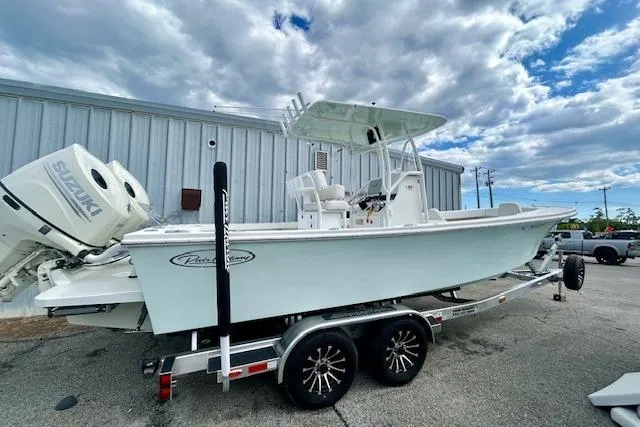 Slide: The Image of 2020 Pair Customs 24 Center Console MV boat on trailer, featuring dual Suzuki engines. - 4