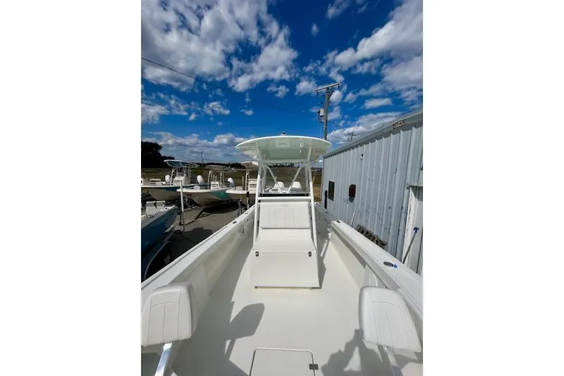 Slide: The Image of 2020 Pair Customs 24 Center Console MV boat under a clear blue sky. - 5