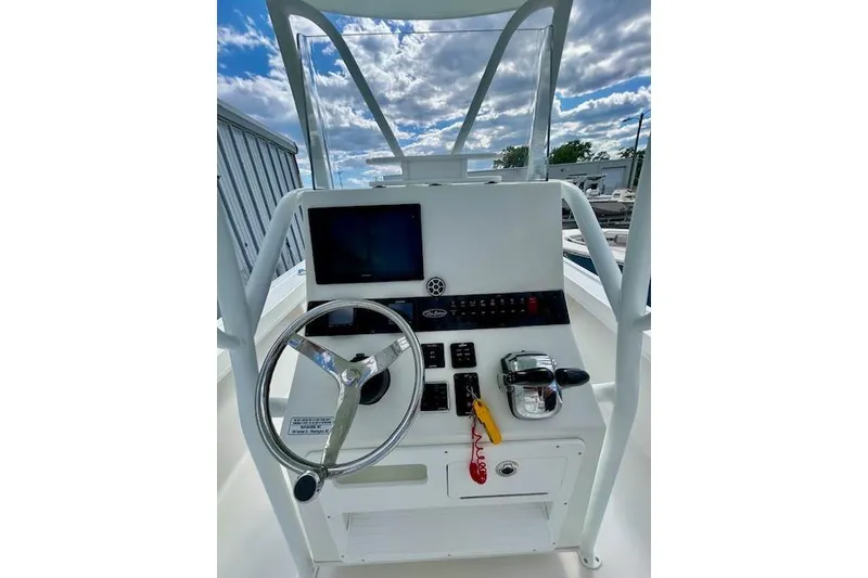 Slide: The Image of 2020 Pair Customs 24 Center Console MV boat dashboard with steering wheel and controls. - 7