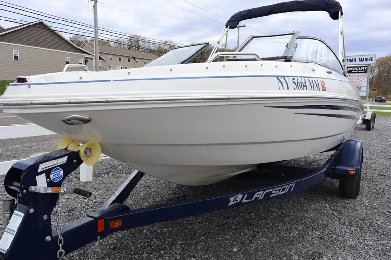The Image of 2018 Larson LX 195 I/O boat on trailer, parked outdoors. - 0