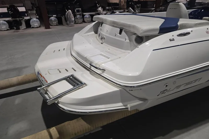 Slide: The Image of 2018 Larson LX 195 I/O boat on trailer, covered and parked outdoors. - 10
