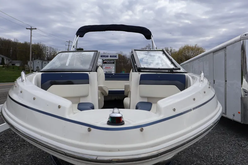 Slide: The Image of 2018 Larson LX 195 I/O boat with blue and white interior, parked outdoors. - 20
