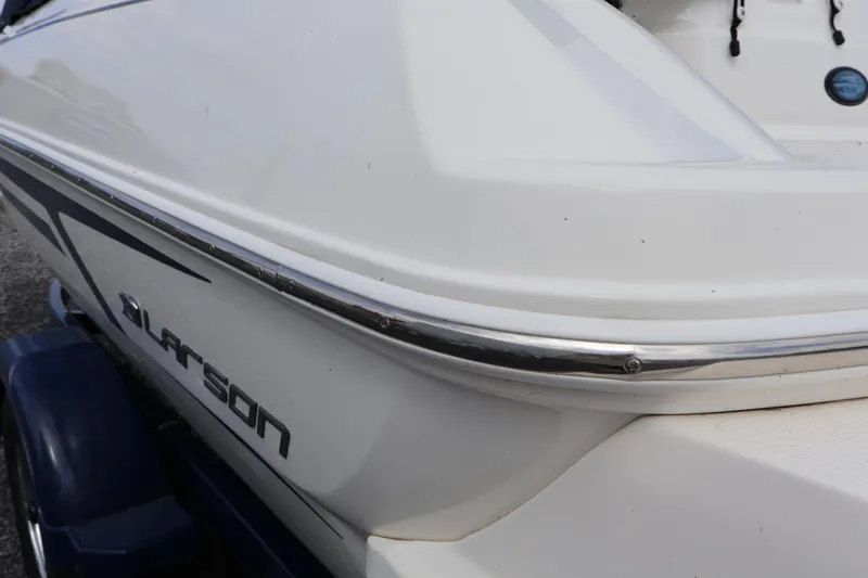 Slide: The Image of 2018 Larson LX 195 I/O boat, white exterior, close-up view. - 22