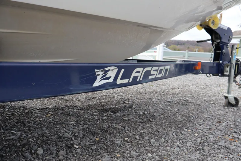 Slide: The Image of 2018 Larson LX 195 I/O boat trailer on gravel surface. - 23