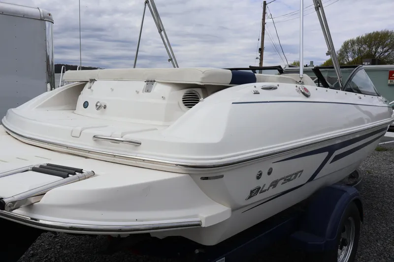 Slide: The Image of 2018 Larson LX 195 I/O boat on trailer, rear view, white exterior. - 24