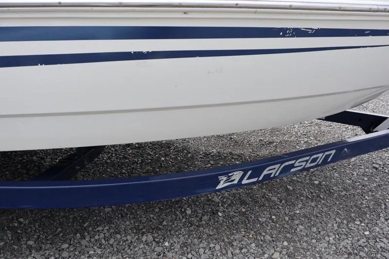 Slide: The Image of 2018 Larson LX 195 I/O boat on a trailer with blue stripes. - 26