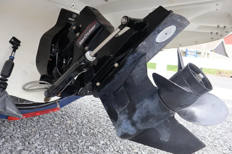 Slide: The Image of Close-up of a 2018 Larson LX 195 I/O boat's MerCruiser outdrive on gravel. - 27