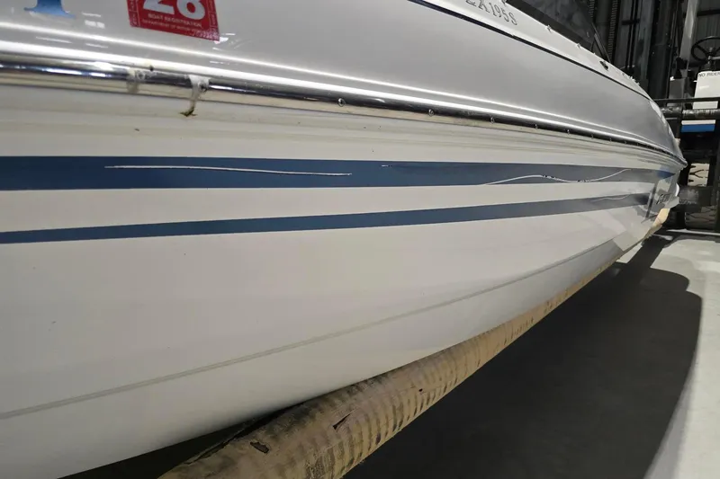 Slide: The Image of 2018 Larson LX 195 I/O boat on trailer, covered and parked outdoors. - 3