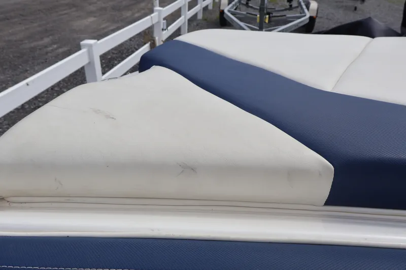 Slide: The Image of Close-up of 2018 Larson LX 195 I/O boat seat with blue and white upholstery. - 34