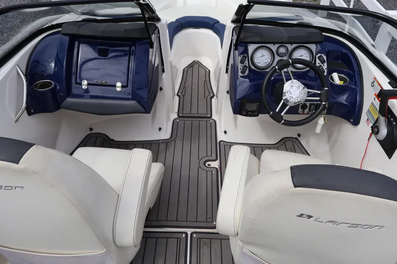 Slide: The Image of Interior of a 2018 Larson LX 195 I/O boat with steering wheel and seating. - 41