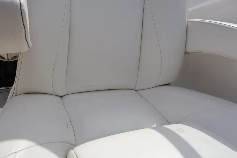 Slide: The Image of White leather seat of 2018 Larson LX 195 I/O boat, close-up view. - 44
