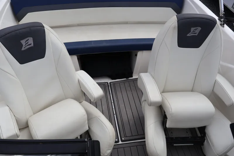 Slide: The Image of 2018 Larson LX 195 I/O boat interior with white seats and gray flooring. - 46