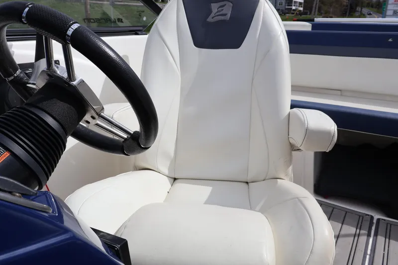 Slide: The Image of Steering wheel and seat of 2018 Larson LX 195 I/O boat interior. - 47