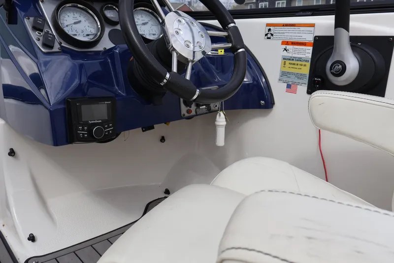 Slide: The Image of Interior view of 2018 Larson LX 195 I/O boat dashboard and steering wheel. - 49