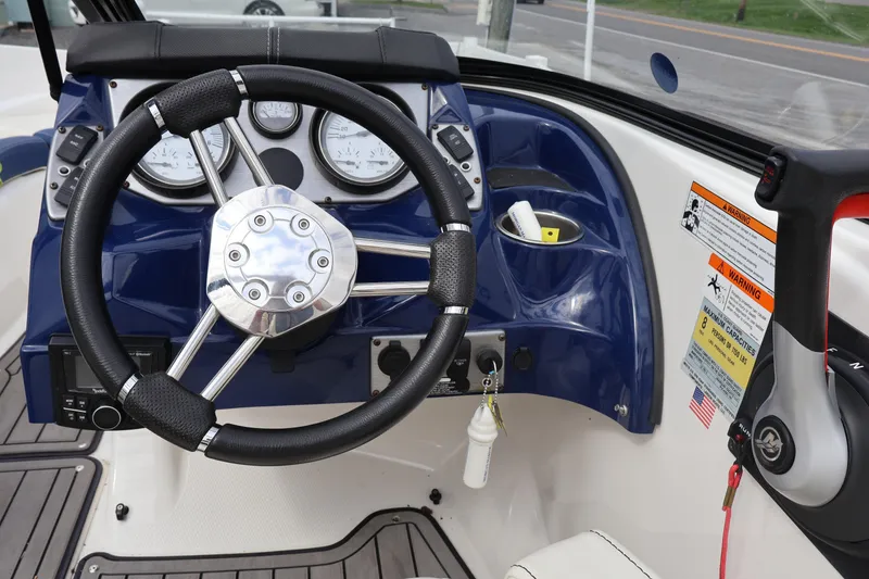 Slide: The Image of Steering wheel and dashboard of 2018 Larson LX 195 I/O boat, featuring gauges and controls. - 50