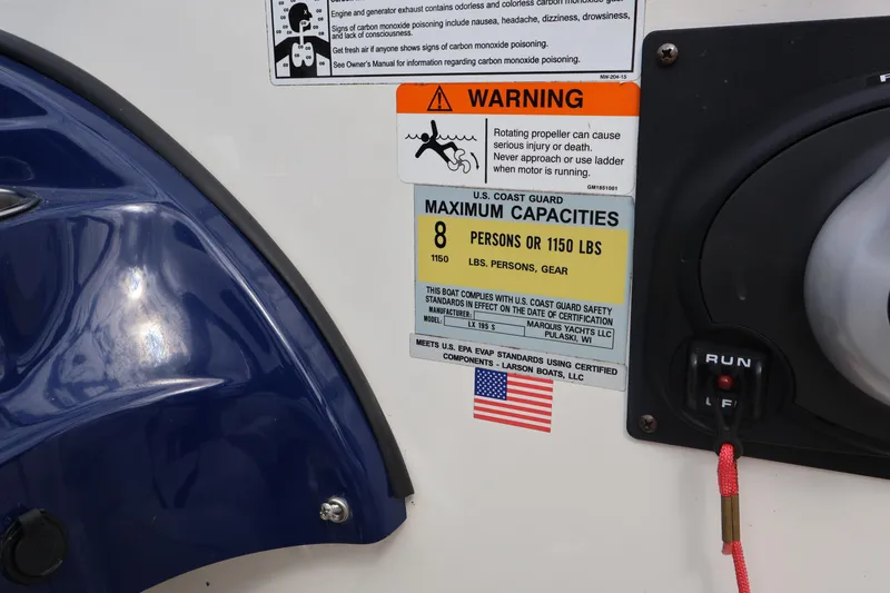 Slide: The Image of Warning and capacity labels on a 2018 Larson LX 195 I/O boat. - 51