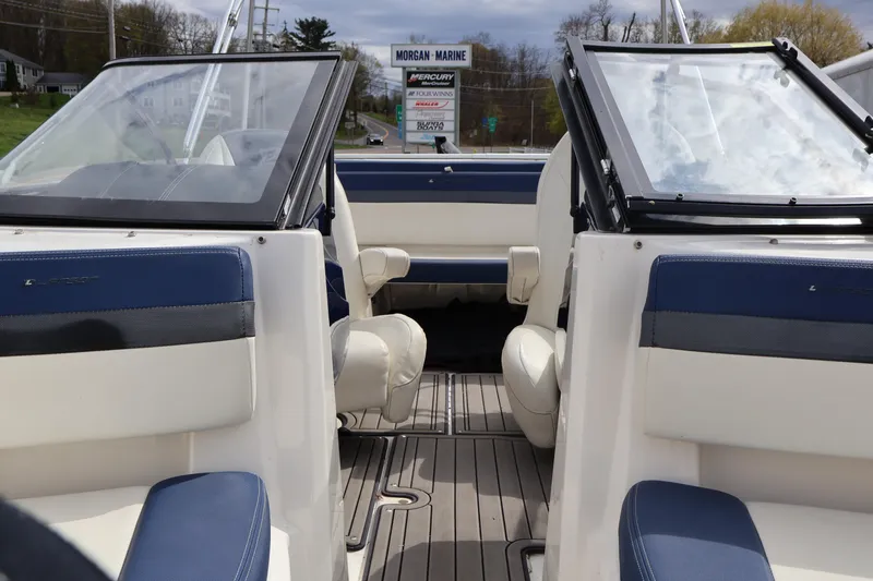 Slide: The Image of 2018 Larson LX 195 I/O boat interior with blue and white seating, docked at Morgan Marine. - 55