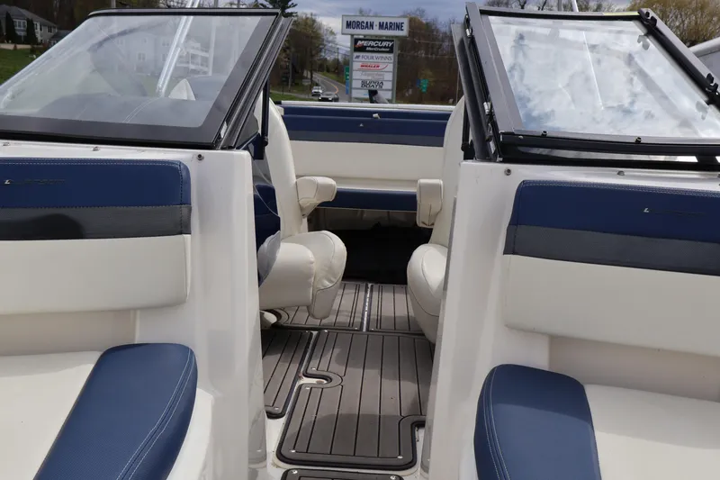 Slide: The Image of 2018 Larson LX 195 I/O boat interior with blue and white seating. - 56