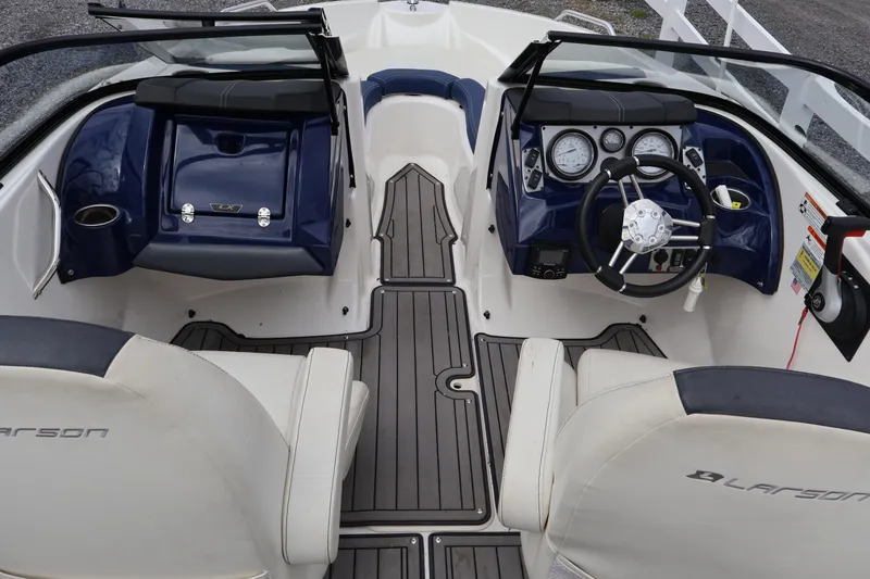 Slide: The Image of 2018 Larson LX 195 I/O boat interior with steering wheel and dashboard controls. - 62