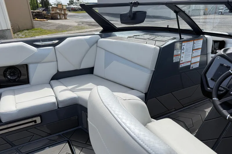 Slide: The Image of 2024 Supreme S220 boat interior with white seating and modern dashboard design. - 10