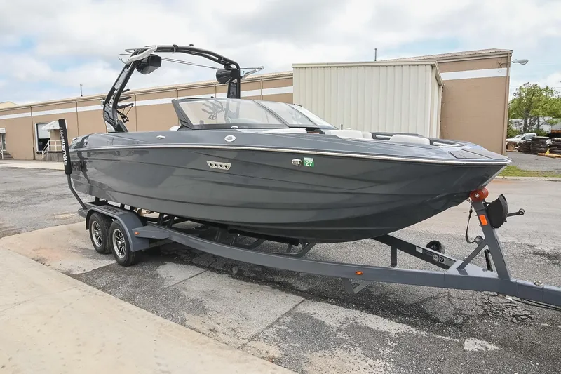 Slide: The Image of 2024 Supreme S220 boat on trailer, sleek design, parked outdoors. - 12