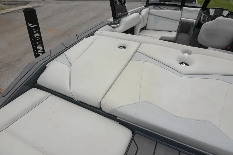 Slide: The Image of 2024 Supreme S220 boat interior with white cushioned seating and modern design. - 20