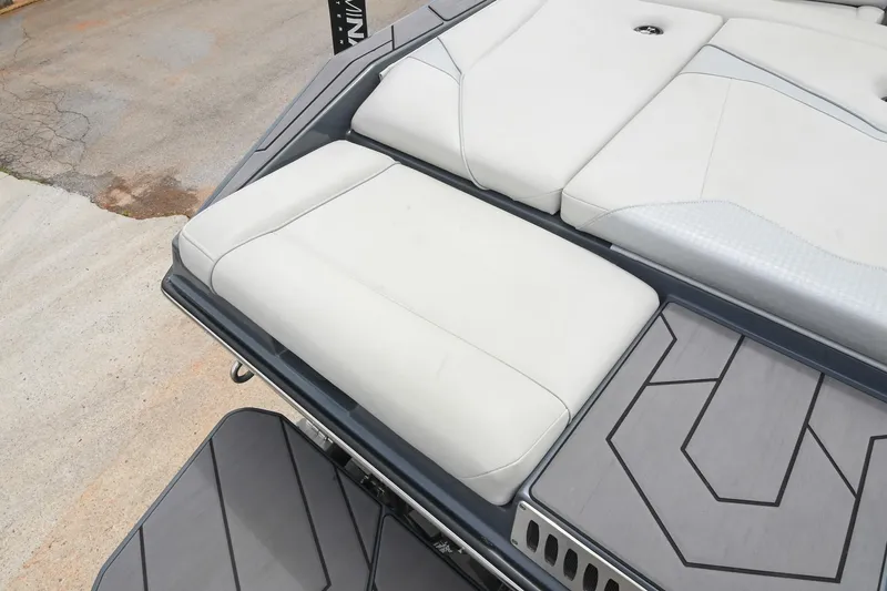 Slide: The Image of 2024 Supreme S220 boat interior with white cushioned seating and sleek design. - 22