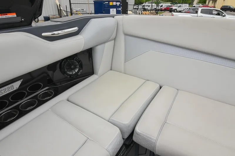 Slide: The Image of Luxurious interior seating of 2024 Supreme S220 boat with cup holders and speaker. - 26