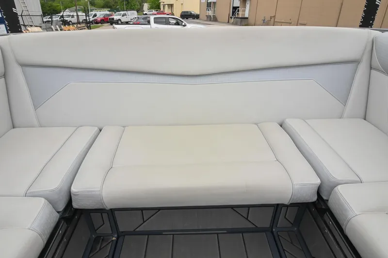 Slide: The Image of 2024 Supreme S220 boat interior seating with light gray upholstery and modern design. - 27