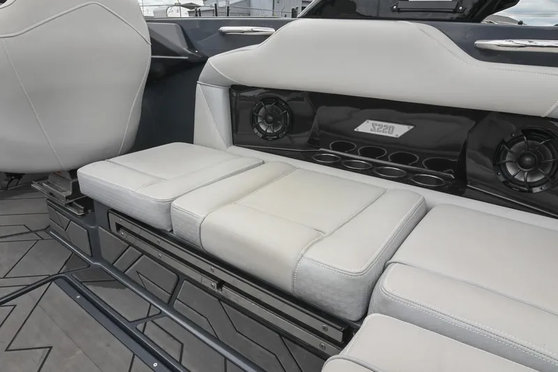 Slide: The Image of 2024 Supreme S220 boat interior with cushioned seating and built-in speakers. - 29
