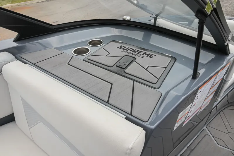 Slide: The Image of 2024 Supreme S220 boat interior with sleek design and dual cup holders. - 30