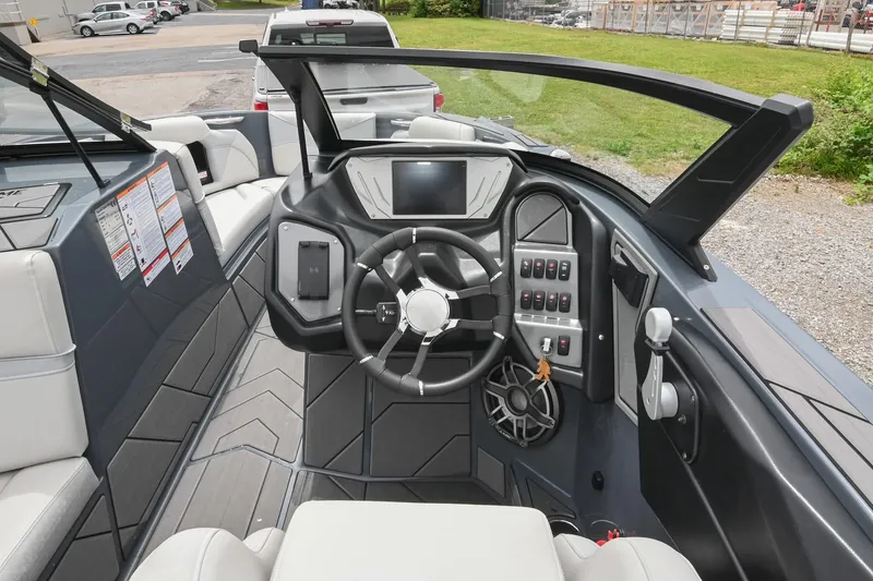 Slide: The Image of 2024 Supreme S220 boat interior with modern dashboard and steering wheel design. - 37