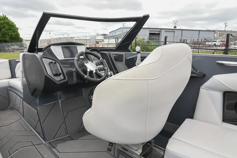 Slide: The Image of 2024 Supreme S220 boat interior with modern dashboard and white seating. - 38