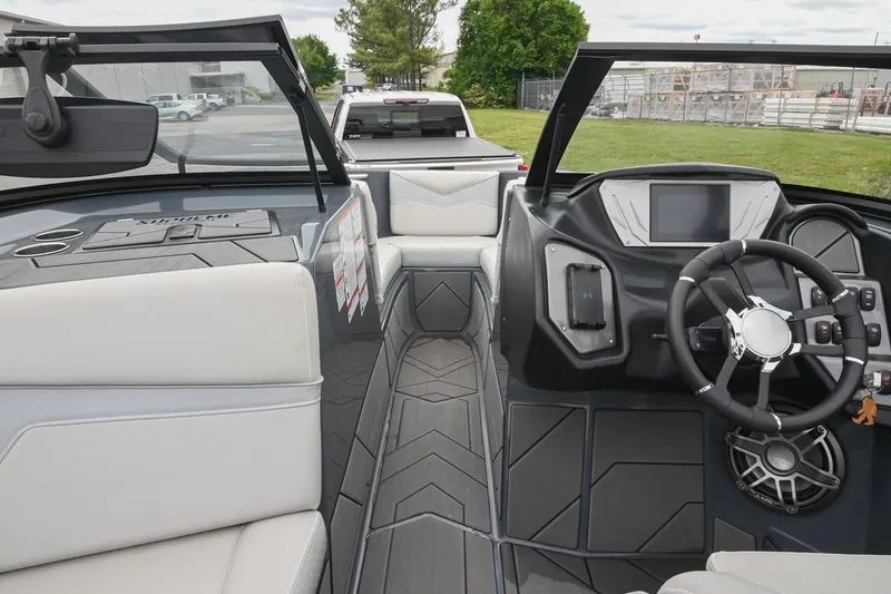 Slide: The Image of 2024 Supreme S220 boat interior with modern dashboard and steering wheel design. - 39