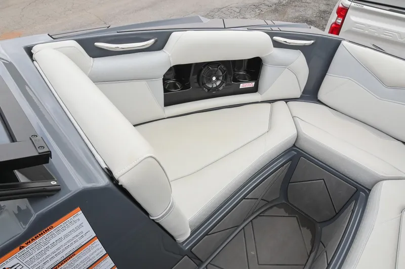 Slide: The Image of 2024 Supreme S220 boat interior with gray and white seating, featuring built-in speakers. - 41