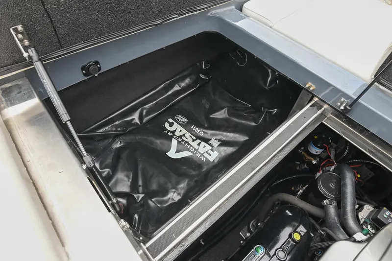 Slide: The Image of 2024 Supreme S220 boat engine compartment with ballast bag and mechanical components. - 42