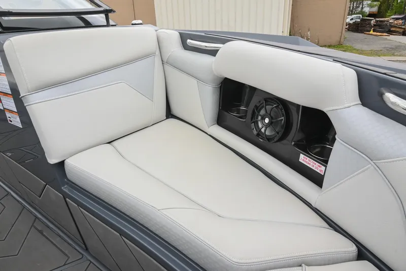 Slide: The Image of 2024 Supreme S220 boat interior with cushioned seating and built-in speaker system. - 45