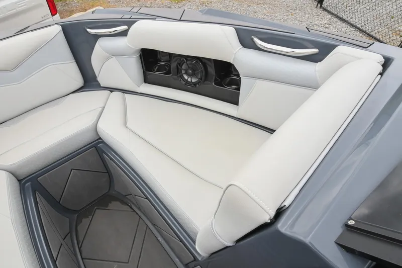 Slide: The Image of 2024 Supreme S220 boat interior with gray and white seating and built-in speaker system. - 47