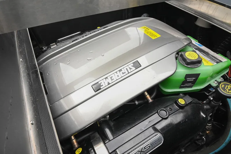 Slide: The Image of 2024 Supreme S220 engine compartment with visible components and branding. - 49
