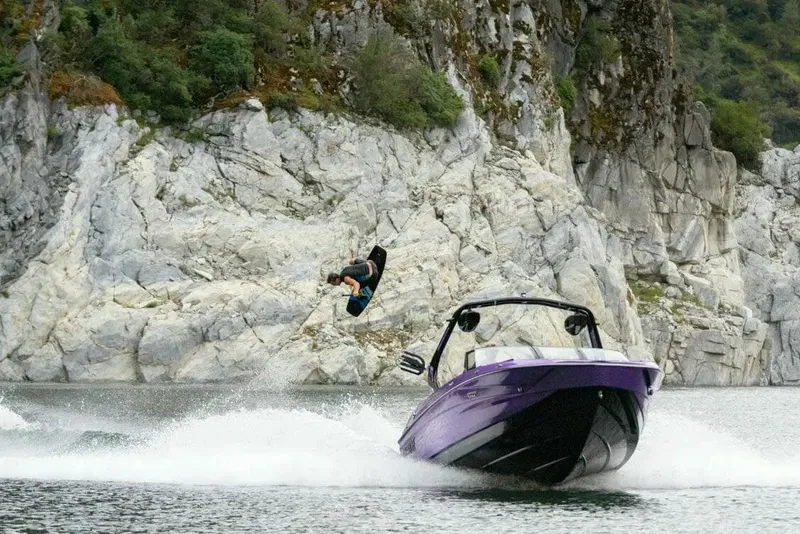 Slide: The Image of Manufacturer Provided Image: 2024 Supreme S220 boat towing wakeboarder near rocky cliffs. - 5
